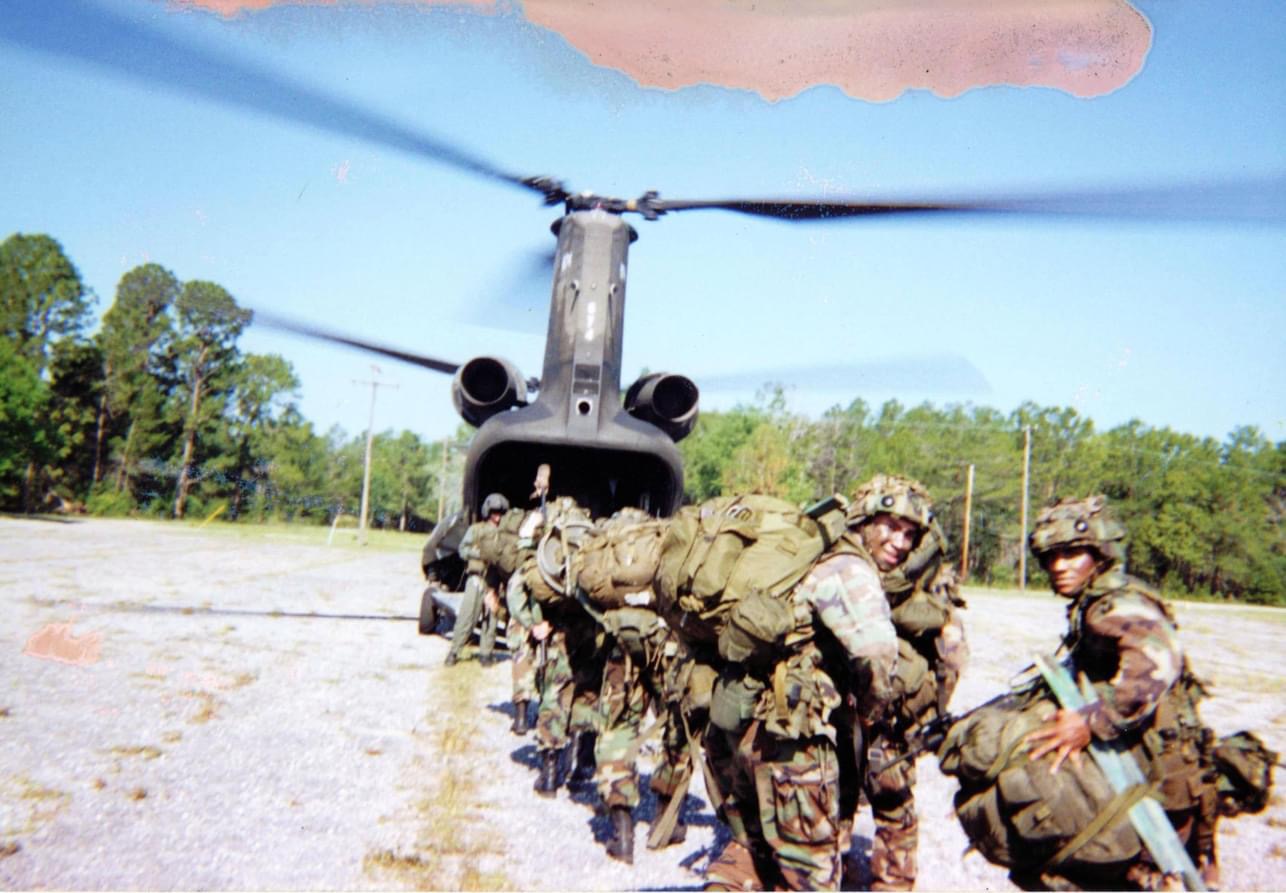 Service members preparing to board a CH-47 Chinook helicopter during training in Panama.
